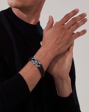 Model wearing Stephen Webster Great Escape clasp in sterling silver with black diamond pavé, blue & orange enamel and mother of pearl back plate