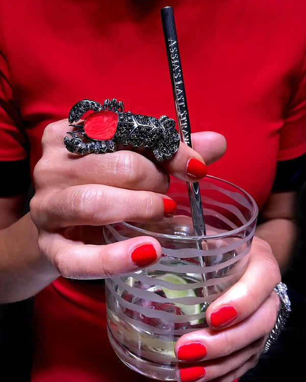 The Last Straw sterling silver reusable straw styled with drinks in a luxury bar setting