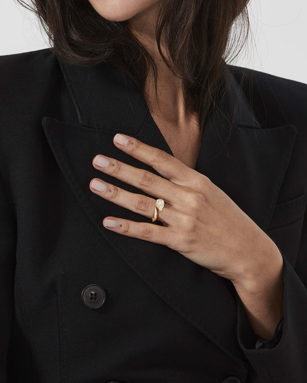 Stephen Webster Thorn Arc Solitaire Ring worn on hand in 18K yellow gold with a white diamond