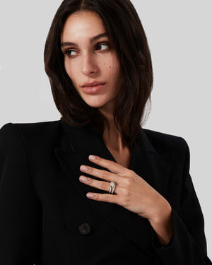 Stephen Webster Thorn Arc Solitaire Ring worn on hand in platinum with a white diamond