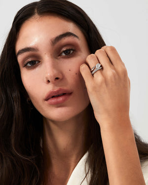 Platinum Thorn Arc Solitaire Slimline wedding band with white diamond styled with matching engagement ring on hand