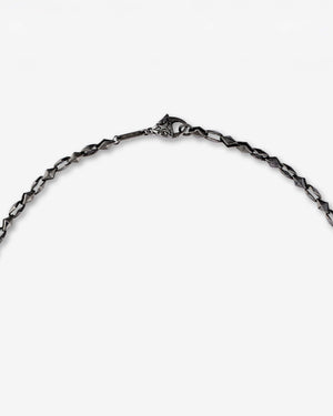 Chain and connection detail of Stephen Webster Thorn Dagger Pendant necklace in black rhodium-plated sterling silver