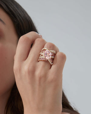 Close-up of central oval morganite with surrounding pink sapphires and white diamond pavé on the Bound Together Cocktail Ring
