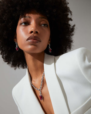 Thorn Embrace Rubellite Pear Drop Necklace styled with other luxury jewellery pieces for a layered look