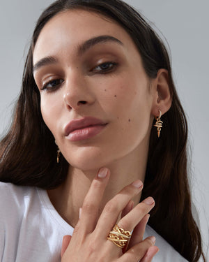 Thorn Embrace Entwined Drop Earrings styled with other luxury fine jewellery, layered contemporary look