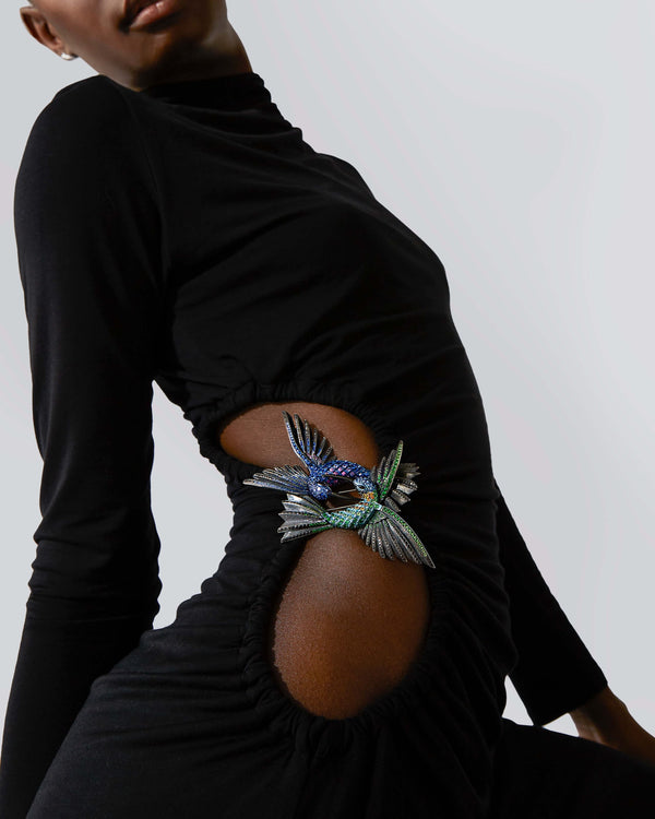 Model wearing Titanium Flight Encounter Brooch pinned on garment — blue titanium gemstone brooch