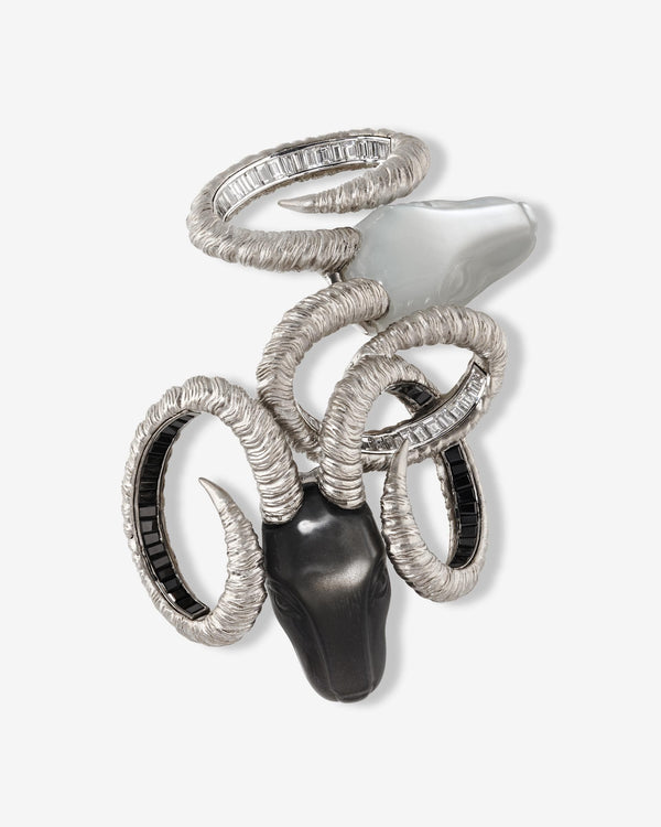 Titanium Ramification Brooch — grey titanium and 18 ct white-gold brooch set with white diamonds, black spinels and carved moonstone heads — front view