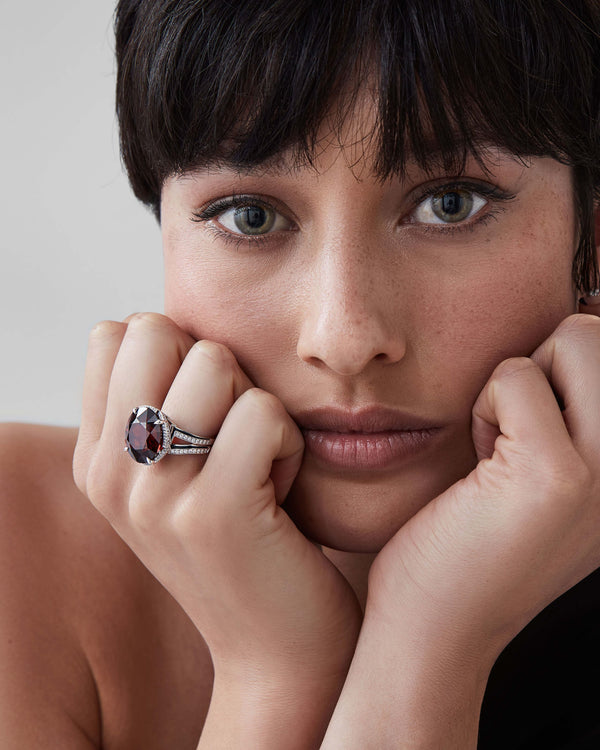 Model wearing Vertigo Impossible red garnet cocktail ring on white-gold band