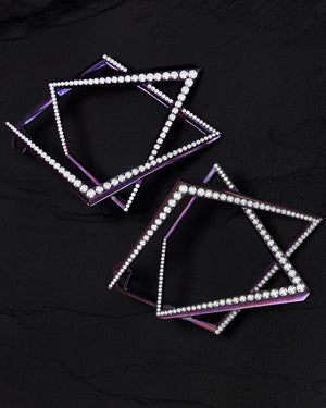 Flat-lay view of Vertigo Light Pink Titanium Rubix Hoops on black background — top-down view