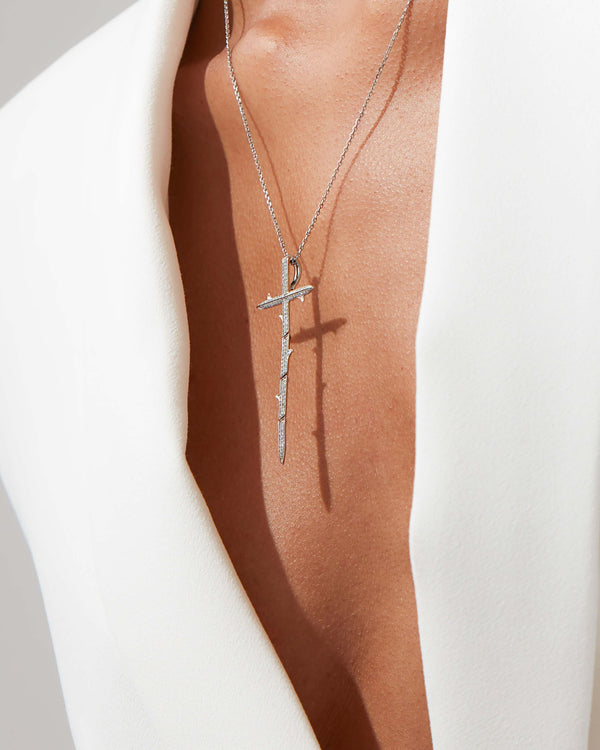 Very Cross white diamond pendant in 18ct white gold worn on model, luxury styling