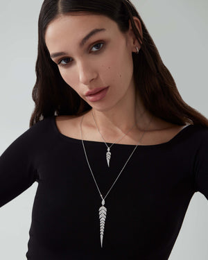 White Diamond Pavé Tail Feather Drop Pendant styled with other feather-inspired fine jewellery pieces