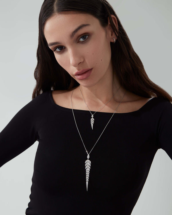 White Diamond Pavé Tail Feather Long Drop Pendant styled with other feather-inspired fine jewellery pieces