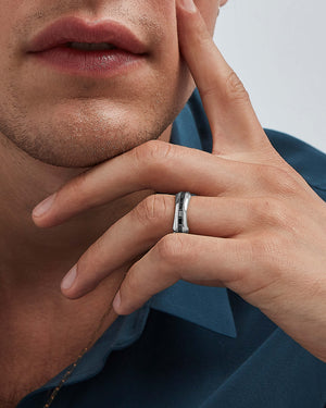 White gold Quadrafoil black baguette diamond men’s wedding band worn on hand