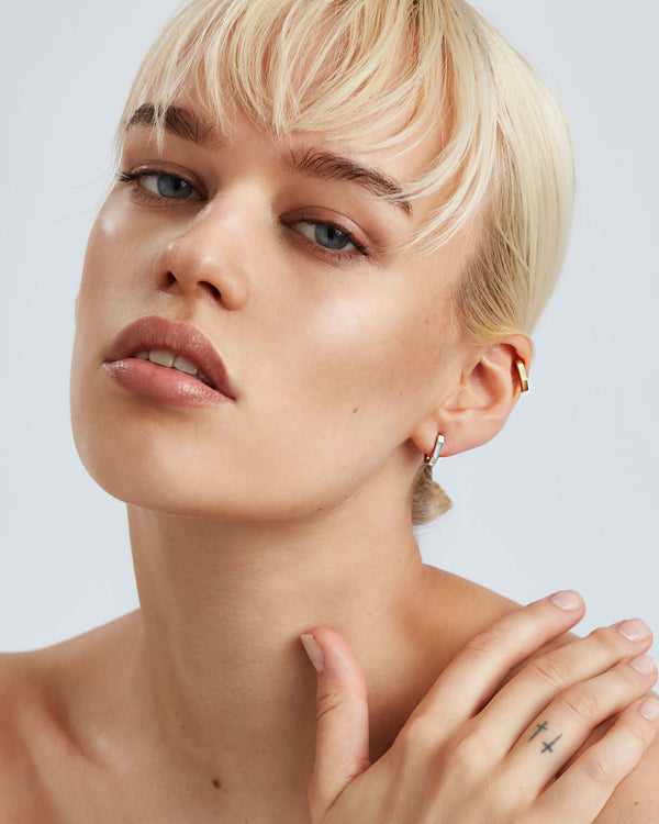 White gold sleepers earrings worn on the ear in 18ct white gold