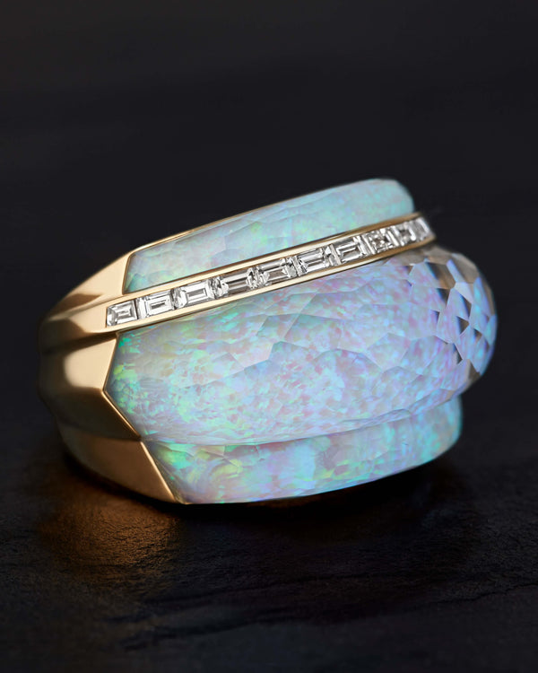 Close-up of white opalescent Crystal Haze gemstone and baguette white diamonds on 18ct yellow gold cocktail ring