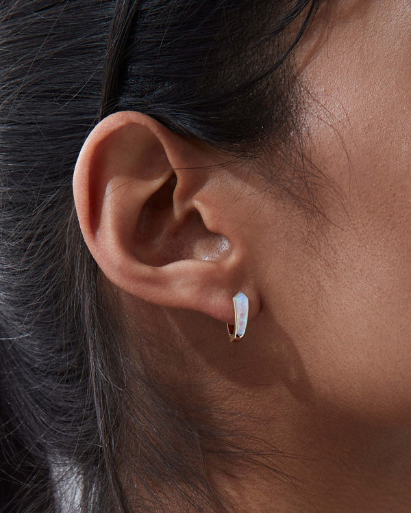 Close-up of white opalescent Crystal Haze and diamond details on 18ct yellow gold sleeper earrings