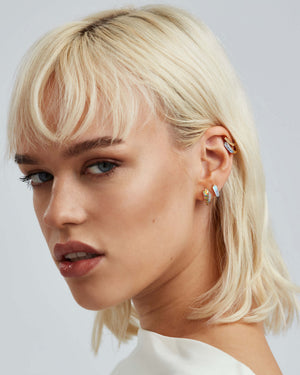 White opalescent Crystal Haze sleeper earrings styled with other Stephen Webster Crystal Haze jewellery