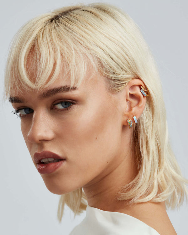 White opalescent Crystal Haze sleeper earrings styled with other Stephen Webster Crystal Haze jewellery