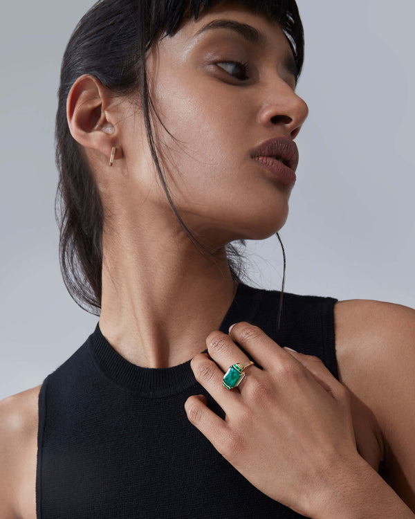 White opalescent Deco slim twister ring worn on hand in 18ct yellow gold