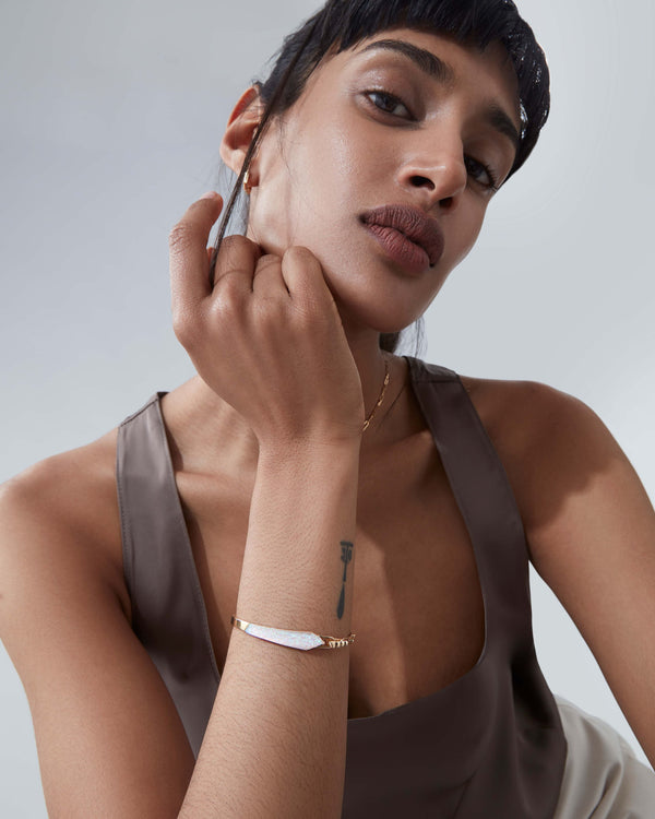 White opalescent and diamonds shard linked bracelet worn on wrist in 18ct yellow gold