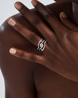 Close-up of Thorn In My Side engagement ring in white gold with round diamond and pavé