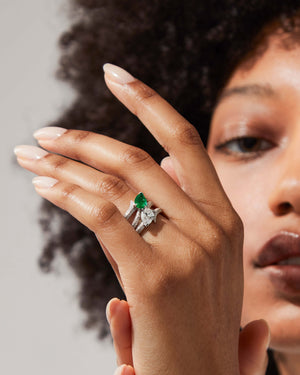 Model wearing 18ct white gold Opposites Attract diamond and emerald ring