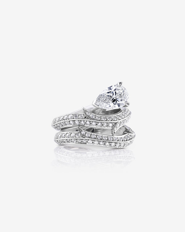 Women’s platinum Thorn Floating Solitaire Pavé engagement ring with pear-cut white diamond and pavé diamonds with matching wedding band
