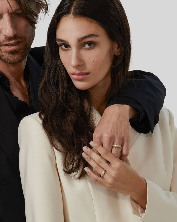 Unisex serpentine yellow gold wedding band with sculptural twist design