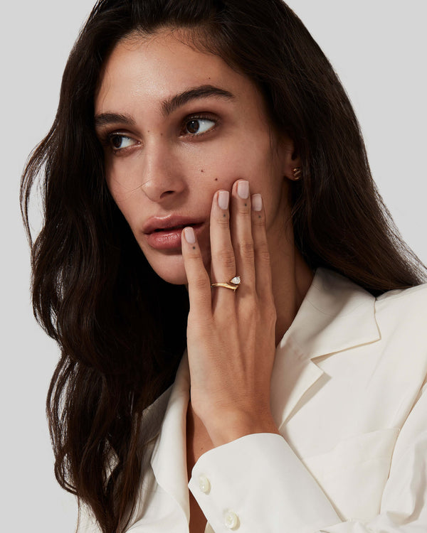 Model wearing 18ct yellow gold Thorn Floating Solitaire Slimline engagement ring with pear diamond