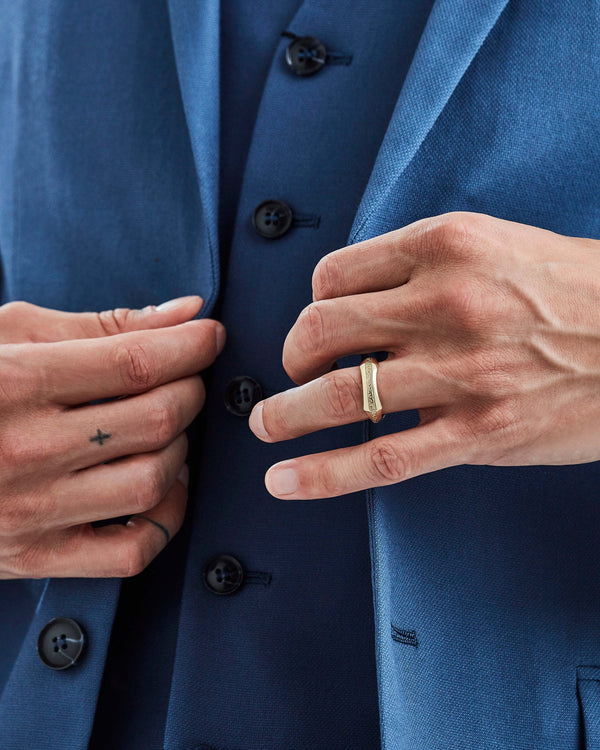 Yellow gold engraved Quadrafoil men’s wedding band worn on hand