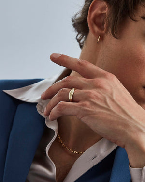 Yellow gold engraved Quadrafoil men’s wedding band worn on hand