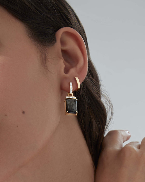 Yellow gold sleepers earrings styled with other Stephen Webster jewellery
